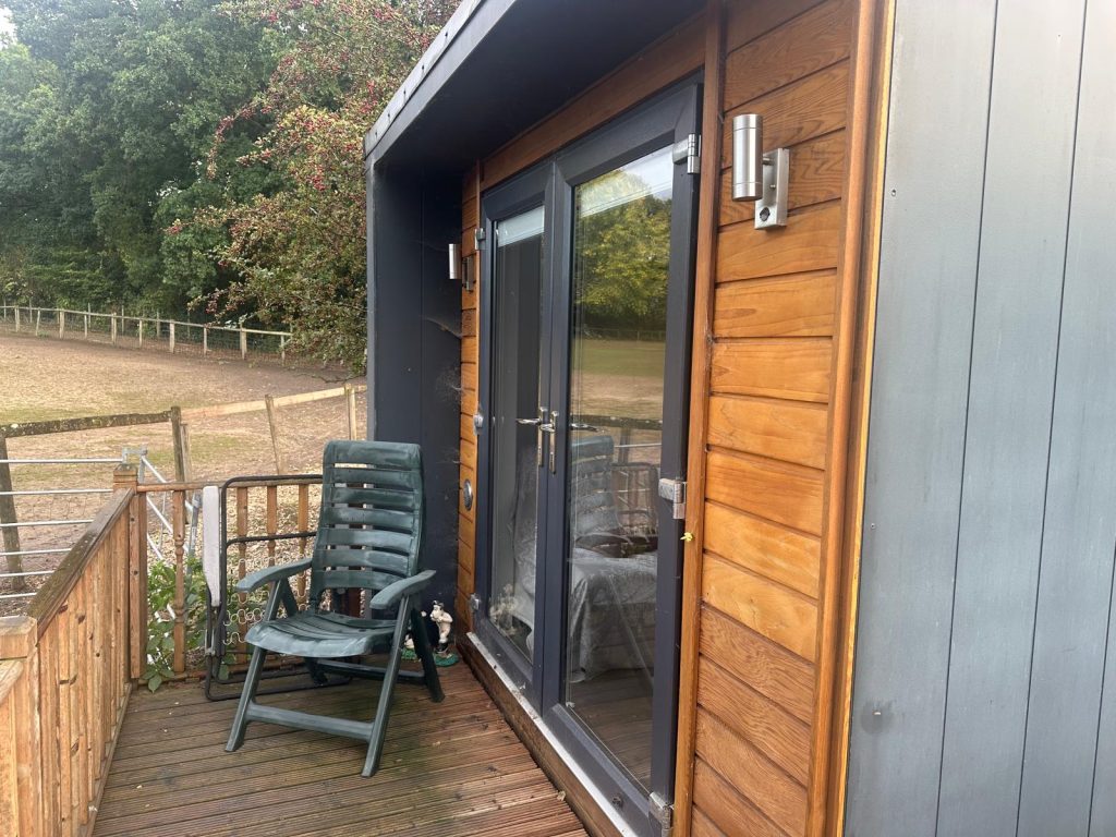Balcony view of the serene alpaca farm in Hampshire, ideal for digital detox retreats and mindfulness experiences.