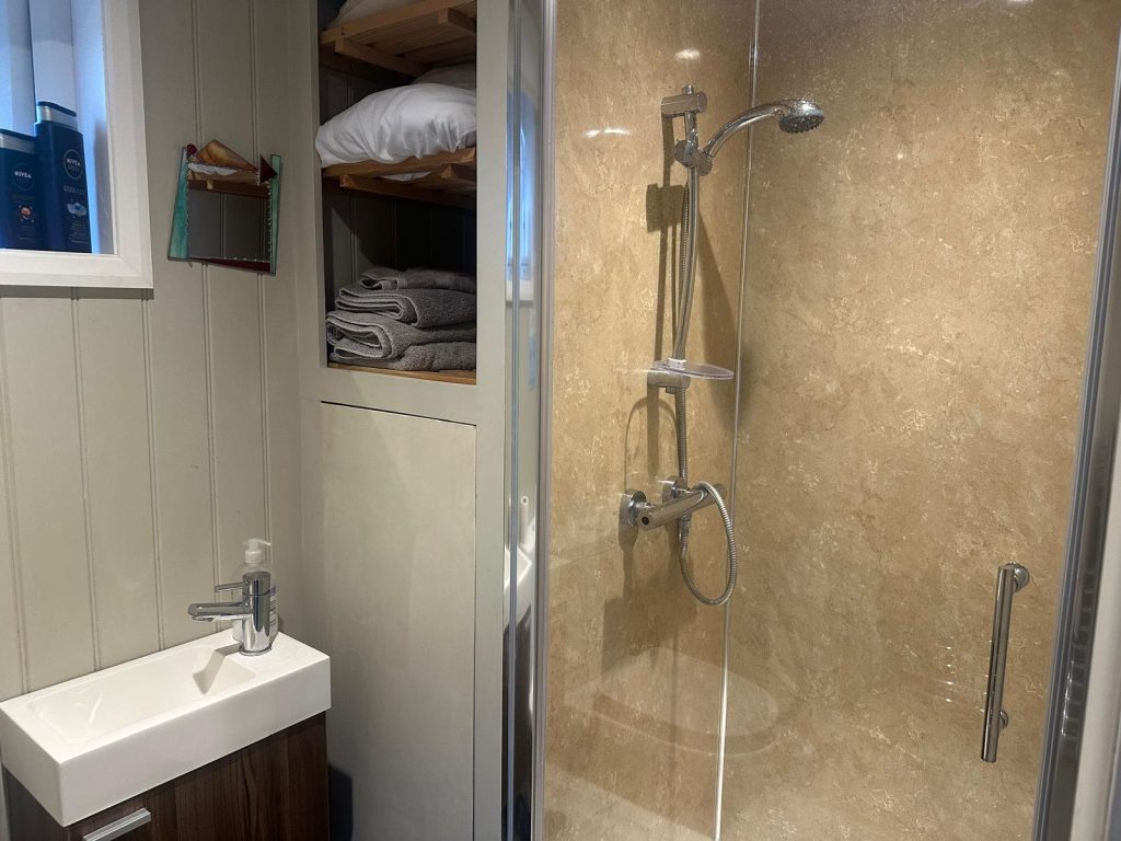 Clean and modern bathroom with shower facilities, providing comfort and privacy for retreat guests.
